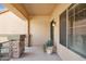 Inviting front porch with stone accents, a potted plant, and a view of the entrance at 21019 N Sansom Dr, Maricopa, AZ 85138