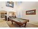 Game room with soaring ceilings, a billiard table, and an open layout flowing into the living spaces at 21019 N Sansom Dr, Maricopa, AZ 85138