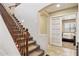 Staircase with carpeted steps and wooden railing leads to the upstairs living areas at 21019 N Sansom Dr, Maricopa, AZ 85138