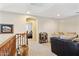 Upstairs hallway with neutral carpet and views into the adjacent bedrooms at 21019 N Sansom Dr, Maricopa, AZ 85138