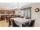 Traditional kitchen boasts dark wood cabinetry, stainless appliances and a breakfast nook with seating at 21019 N Sansom Dr, Maricopa, AZ 85138