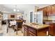 Open concept kitchen flows into living space with stainless appliances and center island at 21019 N Sansom Dr, Maricopa, AZ 85138