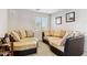 Cozy sitting area features curved couches, plush cushions, and carpet at 21019 N Sansom Dr, Maricopa, AZ 85138