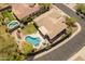 Aerial shot featuring a private backyard pool, desert landscaping, and an expansive rooftop at 2222 W Morse Ct, Anthem, AZ 85086