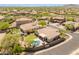 Expansive aerial view of the property featuring a private pool, desert landscaping, and a charming neighborhood at 2222 W Morse Ct, Anthem, AZ 85086