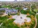 Aerial view of park with basketball court, trees, parking and surrounding homes at 2222 W Morse Ct, Anthem, AZ 85086