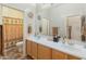 Inviting bathroom featuring dual sinks, ample counter space, and a separate toilet area at 2222 W Morse Ct, Anthem, AZ 85086