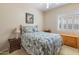 Cozy bedroom with a plush bed, bedside tables, and a window with shutters at 2222 W Morse Ct, Anthem, AZ 85086