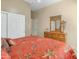 Comfortable bedroom with a tropically designed bedspread and a wooden dresser at 2222 W Morse Ct, Anthem, AZ 85086