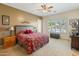 Comfortable bedroom with natural light, ceiling fan, and a view of the backyard pool at 2222 W Morse Ct, Anthem, AZ 85086