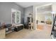 Bedroom or office space with gray walls, a shuttered window, and a glimpse into adjacent living areas at 2222 W Morse Ct, Anthem, AZ 85086