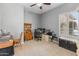 Versatile bedroom with gray walls, a ceiling fan, shuttered windows, and ample space for a desk and storage, ideal for work or relaxation at 2222 W Morse Ct, Anthem, AZ 85086