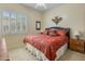 Inviting bedroom with a plush bed, bedside table, and a bright window with shutters at 2222 W Morse Ct, Anthem, AZ 85086
