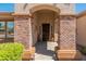Charming home entrance featuring brick columns, desert landscaping, and a welcoming entryway at 2222 W Morse Ct, Anthem, AZ 85086