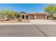 Charming single-story home featuring a three-car garage, desert landscaping, and a welcoming entrance at 2222 W Morse Ct, Anthem, AZ 85086