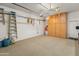 Spacious garage features a speckled epoxy floor, wall-mounted storage cabinets, and overhead tool racks for organization at 2222 W Morse Ct, Anthem, AZ 85086