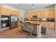 Well-equipped kitchen featuring stainless steel appliances, tile floors, a breakfast bar, and ample cabinet space at 2222 W Morse Ct, Anthem, AZ 85086
