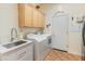 Functional laundry room with washer, dryer, sink, and storage cabinets at 2222 W Morse Ct, Anthem, AZ 85086