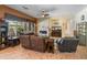Living room with stone fireplace, comfortable seating, and lots of natural light at 2222 W Morse Ct, Anthem, AZ 85086