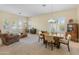 Bright, open-concept living and dining area featuring neutral tones, large windows, and comfortable seating for relaxation and entertaining at 2222 W Morse Ct, Anthem, AZ 85086