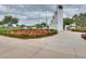 Memorial park with manicured flower beds and commemorative pillars under a cloudy sky at 2222 W Morse Ct, Anthem, AZ 85086
