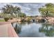Scenic pond featuring waterfall rock feature and lush landscaping within a park at 2222 W Morse Ct, Anthem, AZ 85086