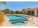 Private backyard oasis with a sparkling pool, spa, covered patio, and beautiful desert landscaping at 2222 W Morse Ct, Anthem, AZ 85086