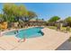 Inviting backyard oasis featuring pool, spa, desert landscaping, outdoor seating and privacy at 2222 W Morse Ct, Anthem, AZ 85086