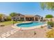 Swimming pool with basketball hoop, outdoor kitchen, covered patio and desert landscaping at 2222 W Morse Ct, Anthem, AZ 85086