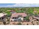 This aerial showcases a property with a private pool, lush landscaping, and serene desert surroundings at 22463 N 54Th St, Phoenix, AZ 85054