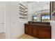 The open bar includes wood cabinetry, granite counters and open shelving at 22463 N 54Th St, Phoenix, AZ 85054