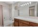 Bathroom featuring a sink, wood cabinet and shower at 22463 N 54Th St, Phoenix, AZ 85054