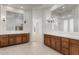 Bathroom with dual sinks, wood cabinets, large mirrors, and tile flooring at 22463 N 54Th St, Phoenix, AZ 85054