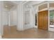 Grand entryway with custom wood door, tile floors, and bright white walls at 22463 N 54Th St, Phoenix, AZ 85054