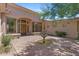 Inviting home entrance with a mature tree, fountain, brick walkway and a custom wood door at 22463 N 54Th St, Phoenix, AZ 85054