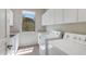 Functional laundry room with ample storage, white cabinets, and modern appliances at 22463 N 54Th St, Phoenix, AZ 85054