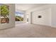 Open living room with large windows, neutral carpet, and an open floor plan at 22463 N 54Th St, Phoenix, AZ 85054