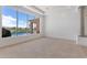 Carpeted living room with bright white walls, natural lighting, and backyard pool views at 22463 N 54Th St, Phoenix, AZ 85054