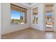 Bright, open living room with large windows, neutral tile flooring and access to the outdoor patio at 22463 N 54Th St, Phoenix, AZ 85054