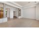 Open living room with neutral carpet, bright lighting, and tall columns at 22463 N 54Th St, Phoenix, AZ 85054