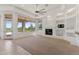 Spacious living room with a fireplace, built-in shelves, and access to outdoor space at 22463 N 54Th St, Phoenix, AZ 85054