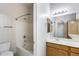 Bathroom showcasing a bathtub with shower, single sink vanity with wood cabinets at 2250 E Deer Valley Rd # 24, Phoenix, AZ 85024