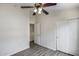 This bedroom features a ceiling fan, closet and laminate floors at 2250 E Deer Valley Rd # 24, Phoenix, AZ 85024