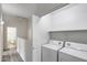 A clean laundry room with a white washer and dryer at 2250 E Deer Valley Rd # 24, Phoenix, AZ 85024
