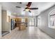 Open-concept living area with tile flooring, a kitchen island, and sliding glass doors bringing in natural light and seamless flow at 2250 E Deer Valley Rd # 24, Phoenix, AZ 85024