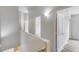 Bright upper level hallway leading to various rooms with light fixtures at 2250 E Deer Valley Rd # 24, Phoenix, AZ 85024