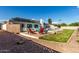 Backyard featuring a pool, patio with seating, desert landscaping, and solar panels on the roof at 2259 E Ivy St, Mesa, AZ 85213