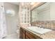 Bathroom with granite countertops, stylish backsplash, a unique window, and tiled floors at 2259 E Ivy St, Mesa, AZ 85213