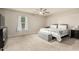 Serene bedroom with neutral tones, carpeted floors, a ceiling fan and a well-lit window at 2259 E Ivy St, Mesa, AZ 85213