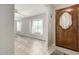 Inviting entryway features wood-look flooring, a decorative front door, and large window at 2259 E Ivy St, Mesa, AZ 85213